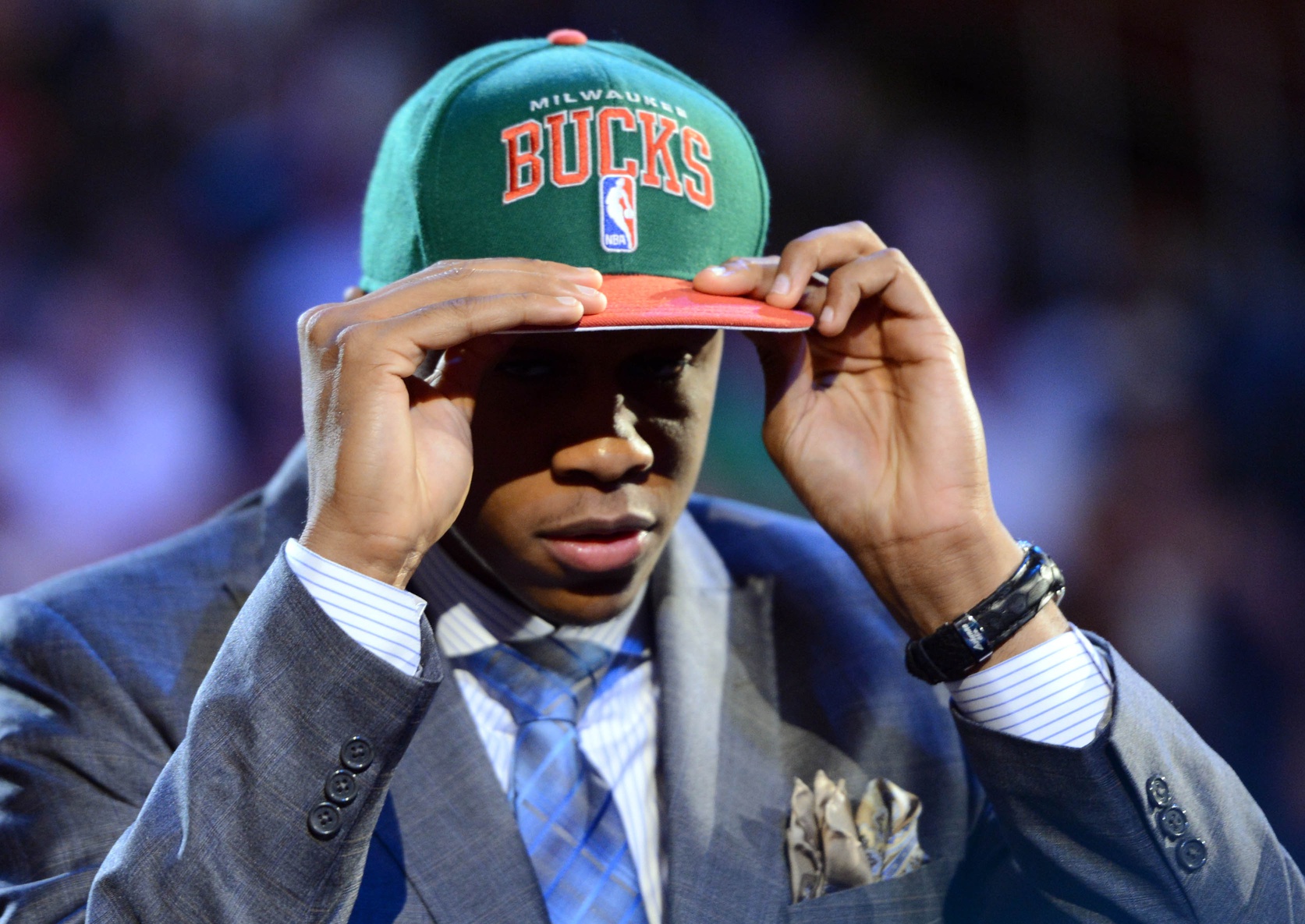 John Henson (North Carolina) puts on a cap after being introduced as the number fourteen overall pick to the Milwaukee Bucks during the 2012 NBA Draft 
